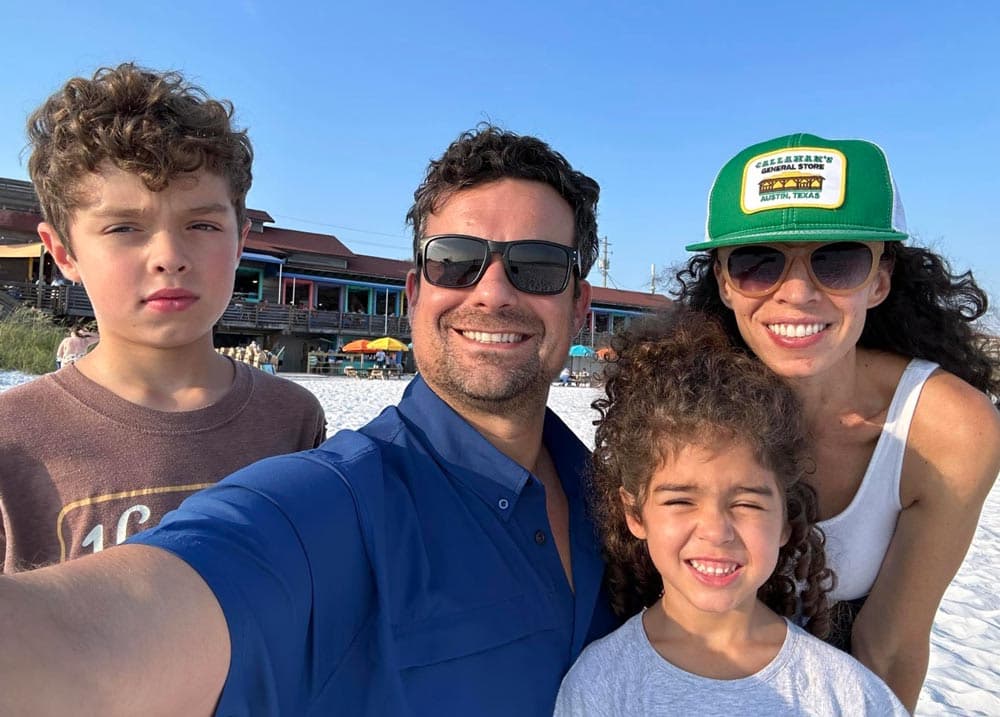 Carson Coots with his wife Anna and their two kids on the beach in Florida